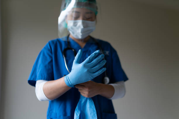 Health care staff wearing gloves and face sheld Health care staff wearing gloves and face sheld sheld stock pictures, royalty-free photos & images