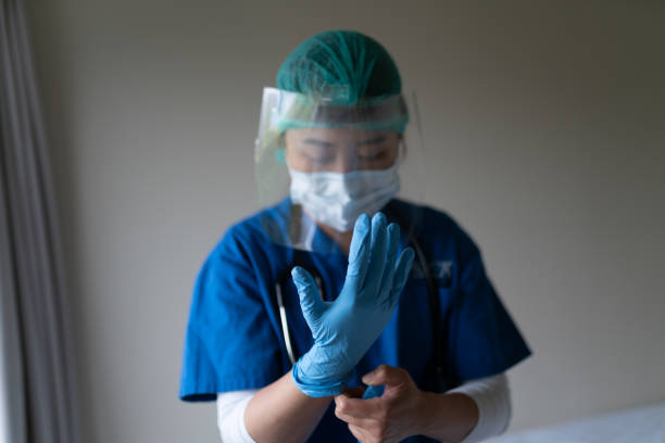 Health care staff wearing gloves and face sheld Health care staff wearing gloves and face sheld sheld stock pictures, royalty-free photos & images