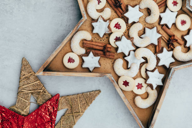 schweizer weihnachtsplätzchen in sternförmiger holzform auf weissem hintergrund. - zimtstern stock-fotos und bilder