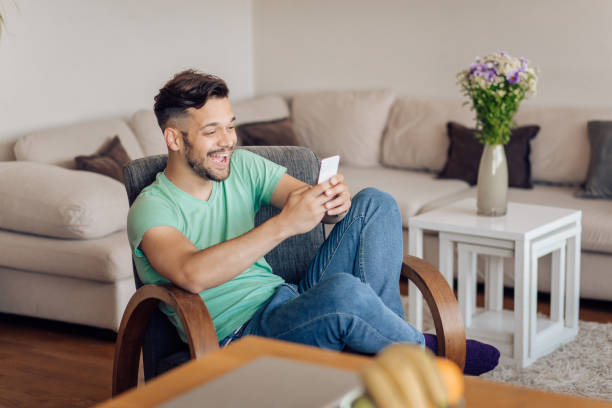 istock Young man relaxing with the internet at home 1354177724
