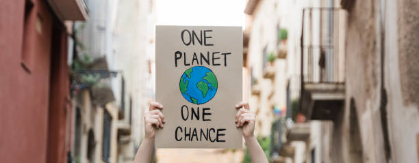 istock Demonstrator on the city protesting against climate change and pollution - Global warming and environment concept 1354178236