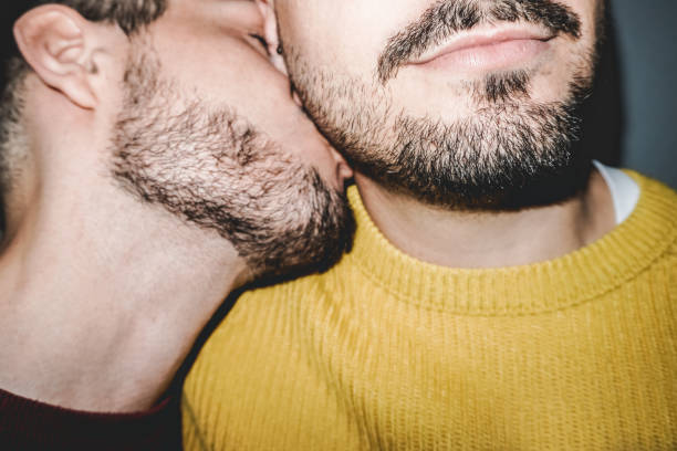 gay male couple kissing on the neck - lgbt, homosexual love concept - vintage filter - homosexual beautiful sensuality love imagens e fotografias de stock