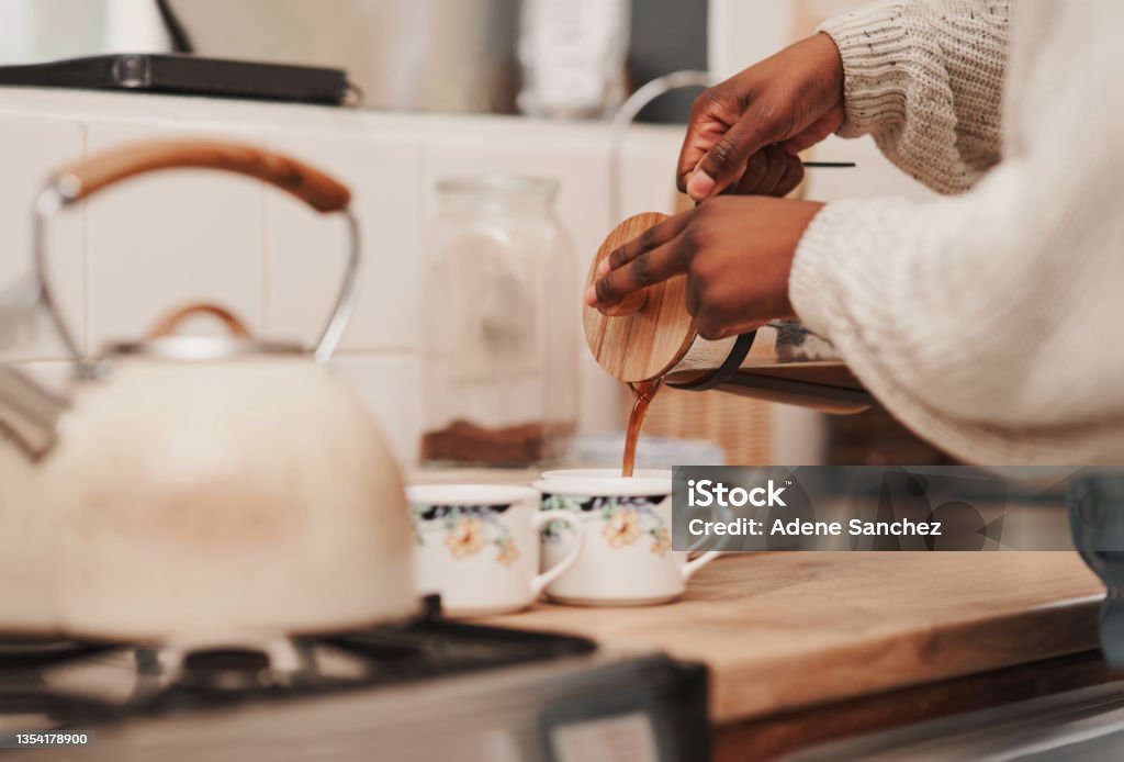 Shot of an unrecognizable person making coffee at home A caffeine boost is just what we need Coffee - Drink Stock Photo