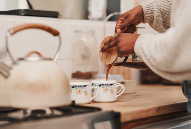 Shot of an unrecognizable person making coffee at home A caffeine boost is just what we need Morning stock pictures, royalty-free photos & images