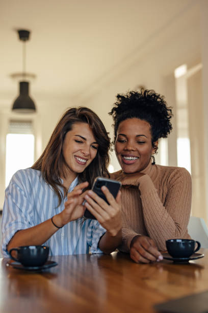 istock Joyful diverse partners, looking at the text on the phone 1354178923