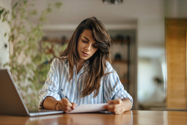 istock Serious young woman, writing a new contract 1354178929