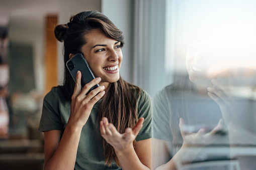 Laughing young woman, calling her friends to meet up