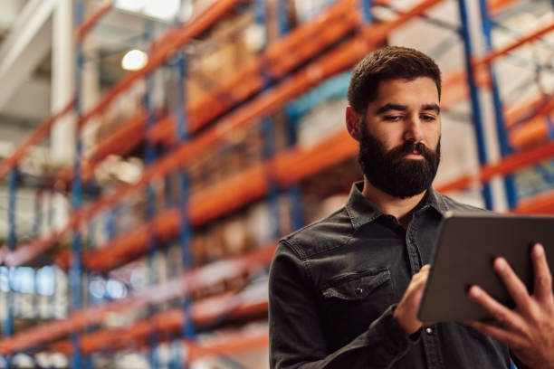 istock Serious caucasian man, contacting his coworkers. 1354179071