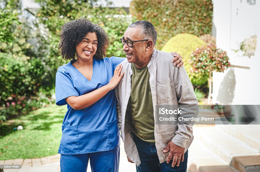 Shot of an attractive young nurse bonding with her senior patient outside I'm always here to catch you if you fall Nurse Stock Photo