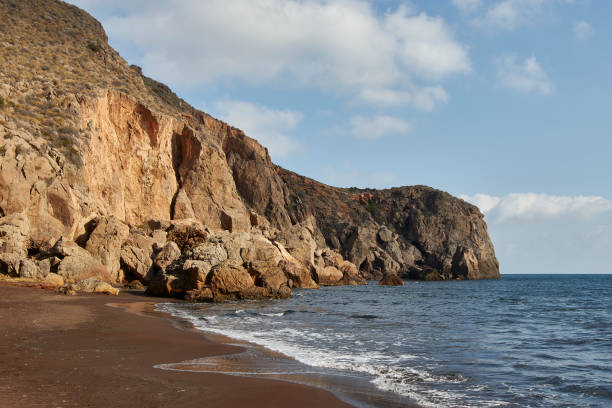 istock Cove in dumps with black sand beach 1354181247