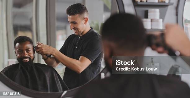 Shot Of A Handsome Young Man Getting His Hair Cut At The Barber Stock Photo - Download Image Now