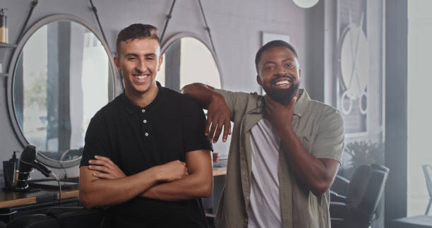 istock Shot of a handsome young barber standing with his client 1354181359