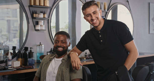 istock Shot of a handsome young barber standing with his client 1354181360