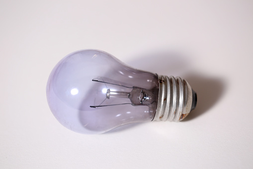 Light bulb on off white background