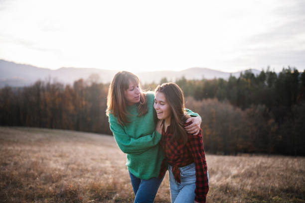 Mother and teenage daughter having a walk in nature