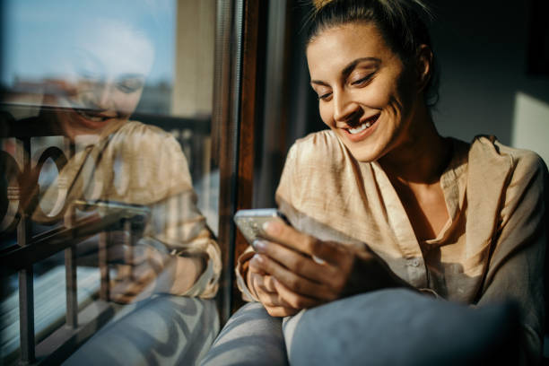 istock Enjoying morning at home with mobile phone in hands 1354183451