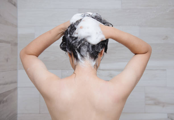 istock woman washing her hair 1354184565