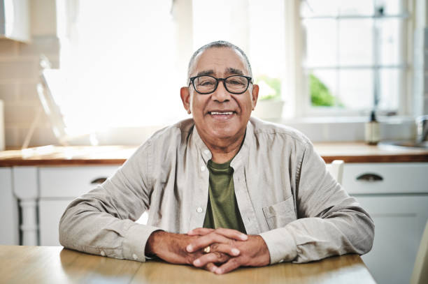 Shot of a senior man sitting alone at home during the day I love spending my days at home senior men stock pictures, royalty-free photos & images