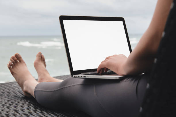 Workaholic woman working with laptop on the beach