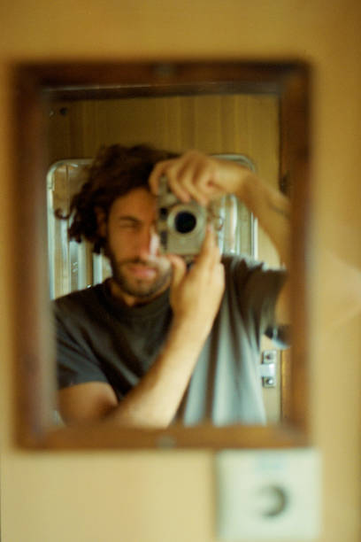 istock Self portrait of man in a mirror 1354188870