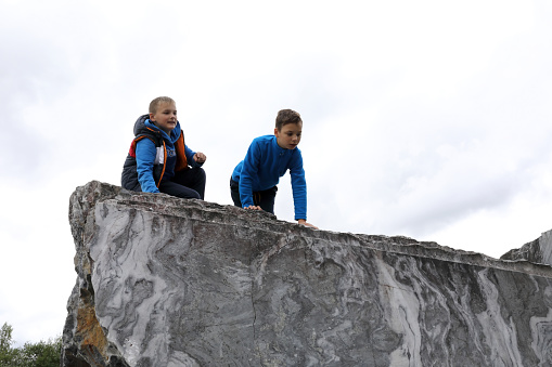 Two children playing in italian quarry, Ruskeala, Karelia