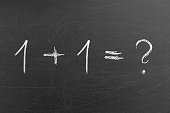 1 plus 1 math equation formula with question mark on a chalkboard