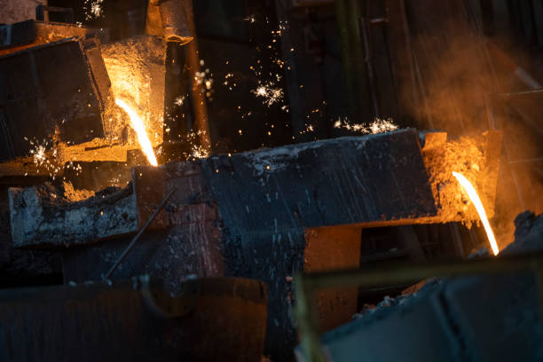 istock Molten metal pouring into the foundry mould 1354189722
