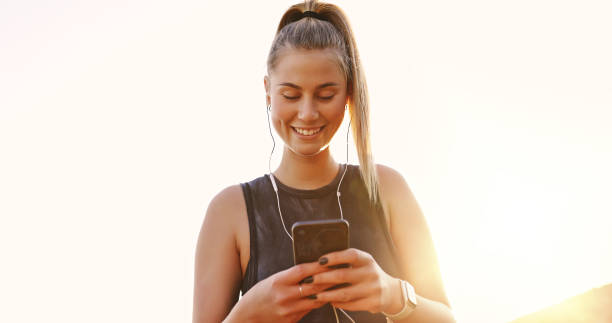 istock Shot of a young woman using her smartphone during a workout 1354190065