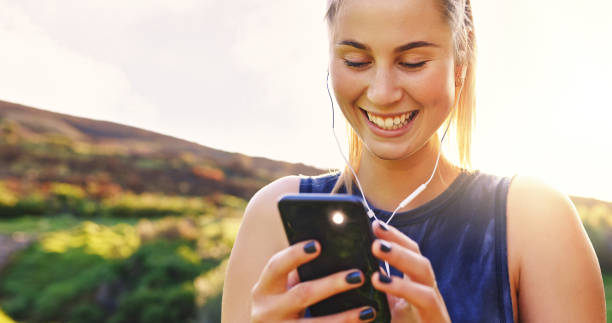 istock Shot of a young woman using her smartphone during a workout 1354190099