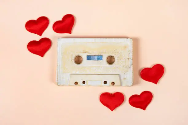 Old Audio Cassette with a Red Hearts on the Paper Background closeup