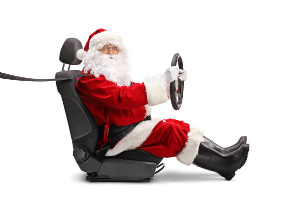 istock Santa Claus holding a steering wheel and looking at camera 1354192448