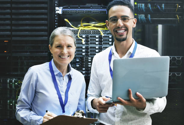 istock Shot of two technicians working together in a server room 1354192768