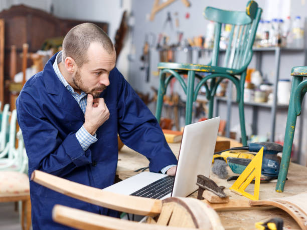 istock Restorer using laptop in process of renovation 1354192927