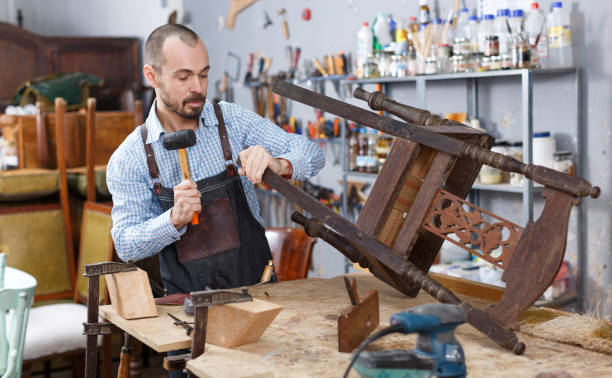 istock Carpenter repairing antique chair 1354192967