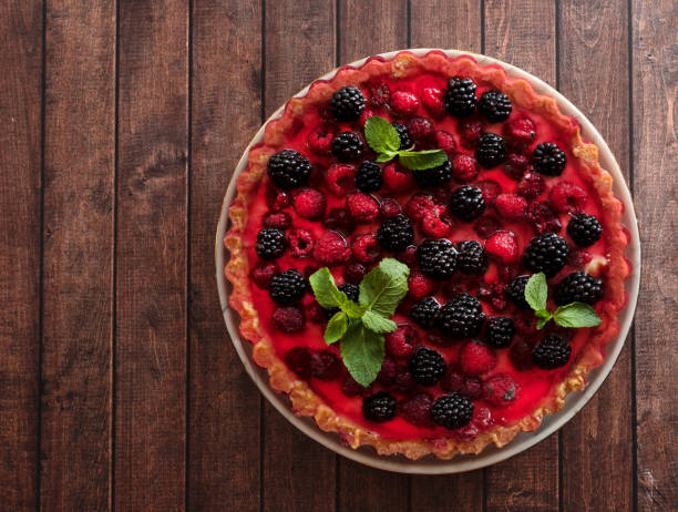 istock Tyrolean pie with fresh raspberries and blackberries on a wooden background. Top view, copy space 1354194059