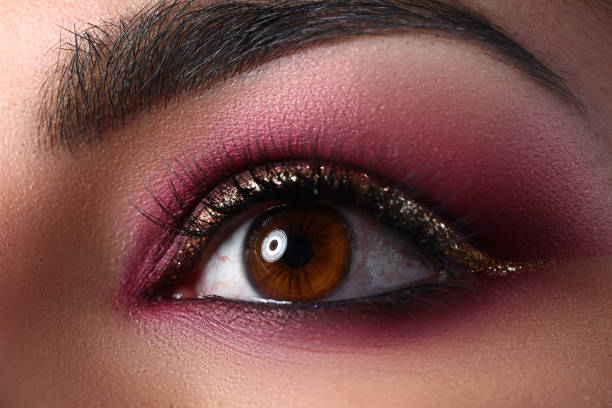 istock Female eye with eyebrows and makeup in pink shades 1354194119