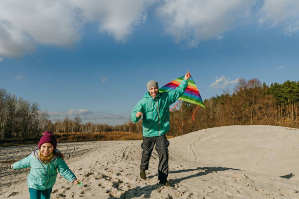 istock Father with his 5 years old daughter prepairing kite to fly 1354194256