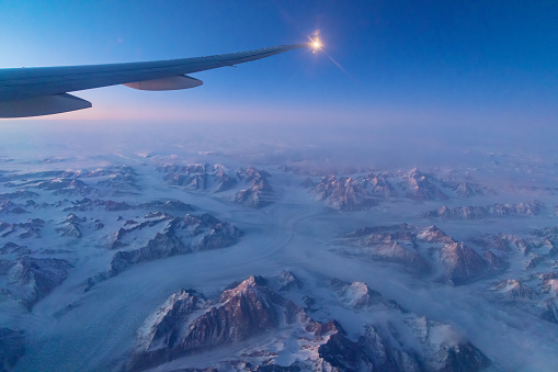 A mesmerizing view with of snow ridge covered mountains in Island, Greenland