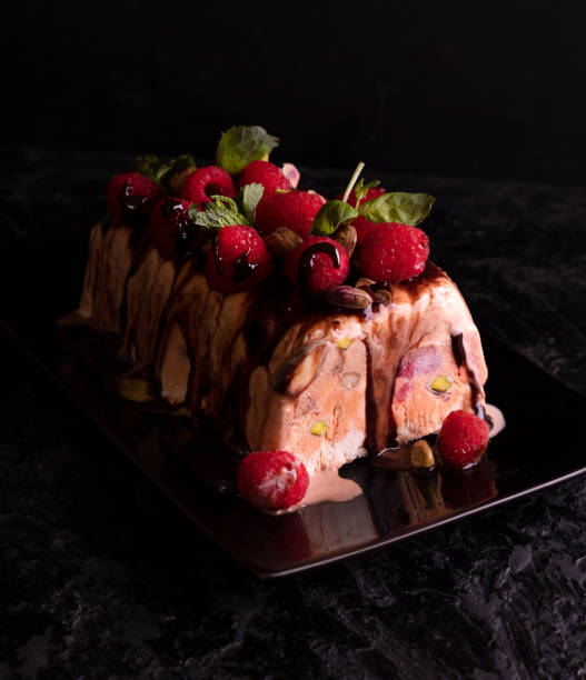 istock Raspberry ice cream dessert; semifredo decorated with mint on a dark background 1354196032