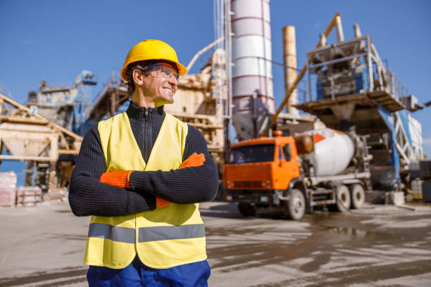istock Cheerful male engineer standing outdoors at industrial site 1354196089