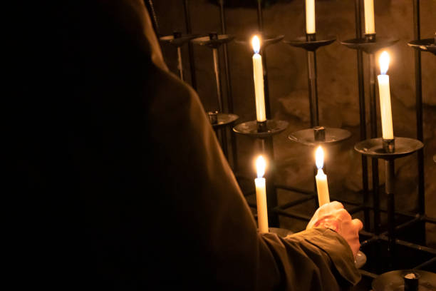 istock Unrecognizable Person Holding Candle in Hand 1354197592