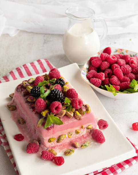 istock Raspberry ice cream dessert; semifredo decorated with mint on a white plate 1354197918