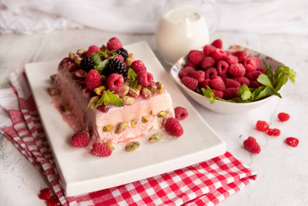 istock Raspberry ice cream dessert; semifredo decorated with mint on a white plate 1354198687