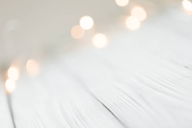 istock white abstract bokeh background behind wooden desk 1354198991