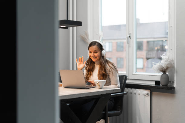 Woman greeting her colleagues in a video call
