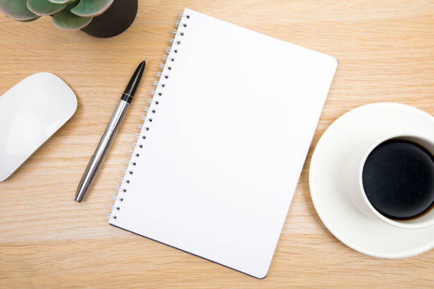 istock open notepad, cup of coffee, pen ,moose on wooden background spiral notebook on table Business, planning, education, morning life working from home concept Top view Flat lay Mock up 1354199233