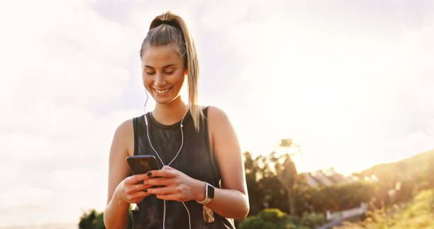 istock Shot of a young woman using her smartphone during a workout 1354200041