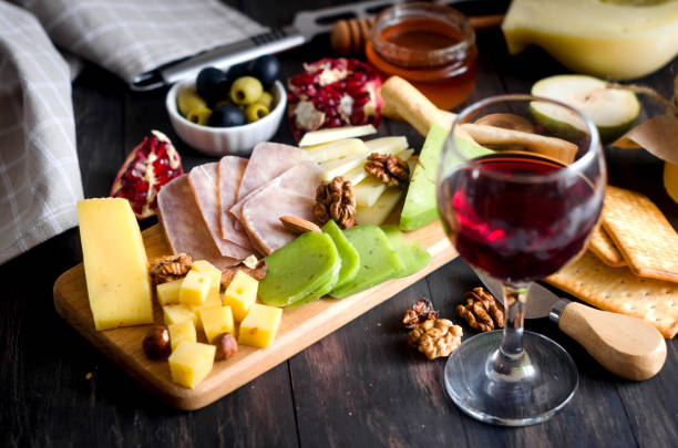 istock Assorted cheese pieces, vegetables, honey, fruits, cookies and nuts 1354200082
