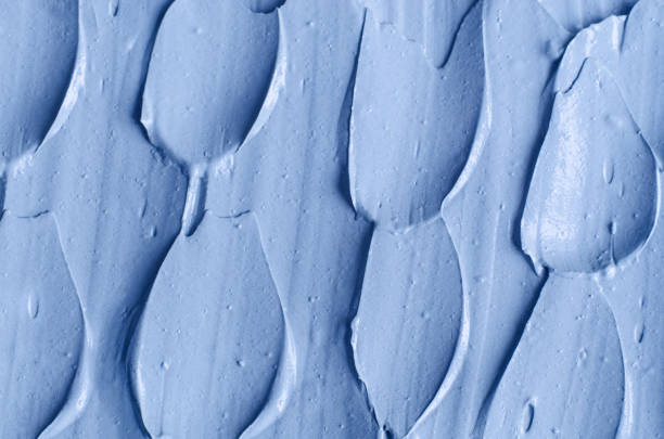 istock Light blue bentonite facial clay (alginate mask, face cream, body wrap) texture close up, selective focus. Abstract background with brush strokes. 1354201601