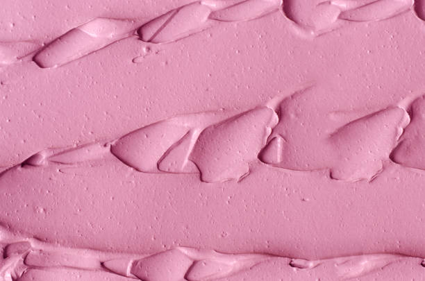 istock Pale rose cosmetic clay (alginate facial mask, face cream, body wrap) texture close up, selective focus. Abstract pink background with brush strokes. 1354201615